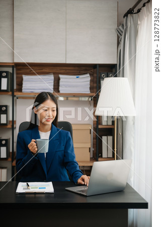 Business woman using tablet and laptop for doing math finance on an office desk, tax, report, accounting, statistics, and analytical research concept Business woman using tablet and laptop for doing math finance on an office desk, tax, report, accounting, statistics, and analytical research concept 128773822