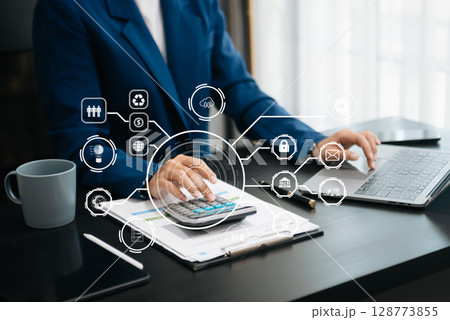 Woman accountant use Laptop and calculator to calculate the company's financial with icon banking on data network of finance and banking with business growth 128773855