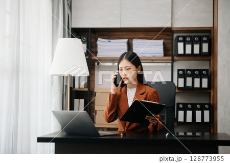 Business woman using tablet and laptop for doing math finance on an office desk, tax, report, accounting, statistics, and analytical research concept Business woman using tablet and laptop for doing math finance on an office desk, tax, report, accounting, statistics, and analytical research concept 128773955