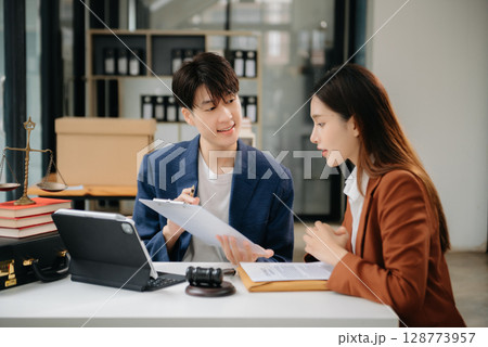 Asian business team and lawyers discussing contract papers sitting at the table. Concepts of law, advice, legal services. at office Asian business team and lawyers discussing contract papers sitting at the table. Concepts of law, advice, legal services. at office 128773957