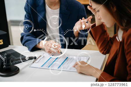 Copyright or patent concept, Business team analyzing data and using smart phone and tablet with virtual screen copyright icon trademark license, Creation ownership against piracy. at office 128773961