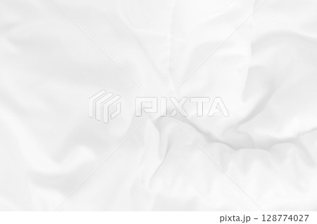 Close up top view of white bedding sheet and wrinkle messy blanket in bedroom after wake up in the morning. 128774027