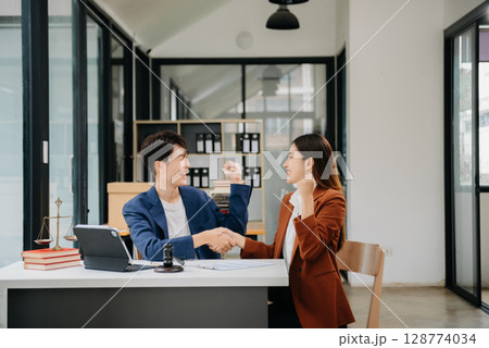 Asian business team and lawyers discussing contract papers sitting at the table. Concepts of law, advice, legal services. at office Asian business team and lawyers discussing contract papers sitting at the table. Concepts of law, advice, legal services. at office 128774034