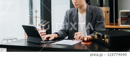 justice advice and law judge legislation concept. tribunal Attorney lawyer working with documents and white gavel on tabel 128774040