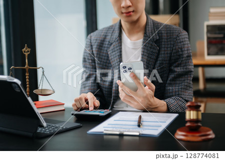 Women counting coins on calculator taking from the piggy bank. hand holding pen working on calculator to calculate on desk about cost at home office. Women counting coins on calculator taking from the piggy bank. hand holding pen working on calculator to calculate on desk about cost at home office. 128774081