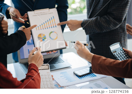 Business people meeting at office writing notes about sticky notes Laptop,tablet  Planning and Brainstorming Strategies of Colleagues 128774156