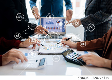 Co working team meeting concept,business with smart phone and laptop and digital tablet computer in office with virtual interface icons Co working team meeting concept,business with smart phone and laptop and digital tablet computer in office with virtual interface icons 128774159
