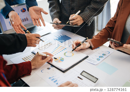 Business People Planning Strategy Analysis Office Concept. writing notes about sticky notes Laptop,tablet Planning and Brainstorming Strategies in office Business People Planning Strategy Analysis Office Concept. writing notes about sticky notes Laptop,tablet Planning and Brainstorming Strategies in office 128774161