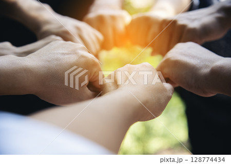 Diverse multiethnic Partners hands together teamwork group of multiracial people meeting join hands togetherness. Diversity people hands join empower partnership teams connection volunteer community 128774434