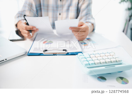 Woman calculating monthly home expenses, taxes, bank account balance and credit card bills payment, Income is not enough for expenses. financial planning, business calculate tax, investment finance. 128774568
