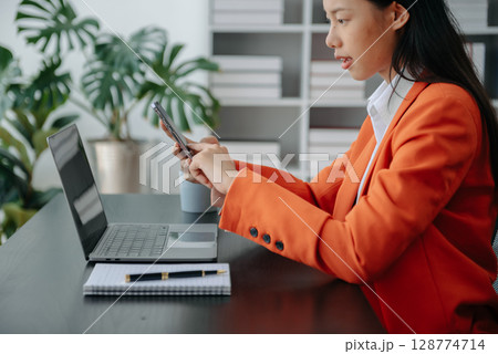 Working Process in Modern Office. Young Woman Account Manager Working at Table with New Business Project. Using Contemporary Laptop. Working Process in Modern Office. Young Woman Account Manager Working at Table with New Business Project. Using Contemporary Laptop. 128774714