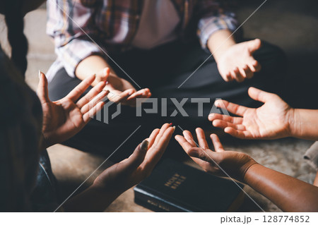 Close up group christians hands pray to God with spiritual faith on holy bible in catholic church. religion worship prayer ask god bless grace jesus believe. Christianity religion prayer holy worship 128774852