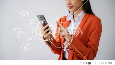 Businesswoman hand working digital marketing media in virtual screen with mobile phone and modern compute with VR icon diagram at office 128774868