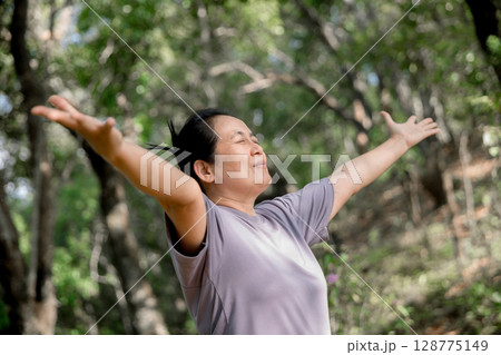 Grateful woman having HOPE praying to God. Spiritual girl smiling to sky. Happy female being thankful. Spiritual girl praying with hope. Positive asian young woman feeling hope and faith looking up. 128775149