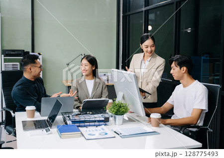 Business team discuss at meeting room. working together with laptop ,tablet and smart phone on desk Financial Business team discuss at meeting room. working together with laptop ,tablet and smart phone on desk Financial 128775493