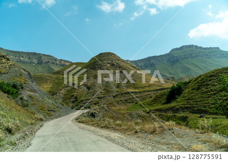 View from the car of an asphalt road in the mountainous area of Dagestan View from the car of an asphalt road in the mountainous area of Dagestan 128775591