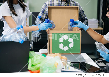 Eco-friendly teamwork with this office recycling scene. Perfect for showcasing sustainability, collaboration, and environmental consciousness 128775612