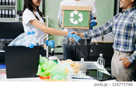 Eco-friendly teamwork with this office recycling scene. Perfect for showcasing sustainability, collaboration, and environmental consciousness Eco-friendly teamwork with this office recycling scene. Perfect for showcasing sustainability, collaboration, and environmental consciousness 128775786