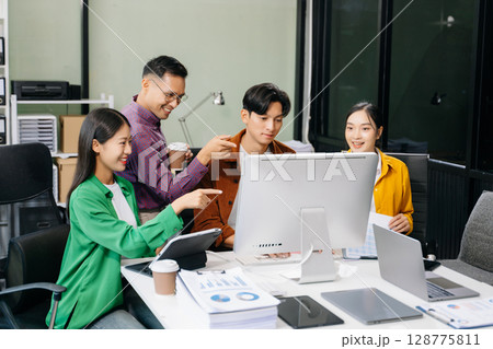 Business team discuss at meeting room. working together with laptop ,tablet and smart phone on desk Financial Business team discuss at meeting room. working together with laptop ,tablet and smart phone on desk Financial 128775811