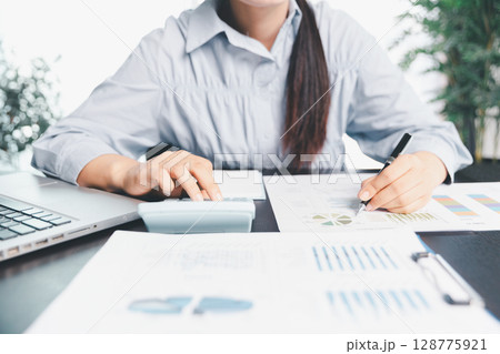 Business woman analyze calculate company financial, tax results office accounting statistics analytical research. calculating business balance prepare tax reduction. Tax deduction planning concept. 128775921