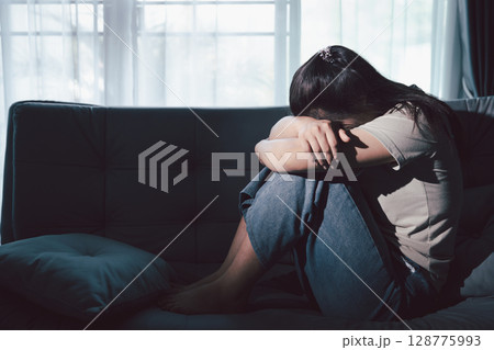 Depression woman sit on sofa. Despair sorrow person sitting alone and hugging knees, Boring sad upset frustrated stressed. struggling to find hope amid suffocating burden. mental health concept. 128775993