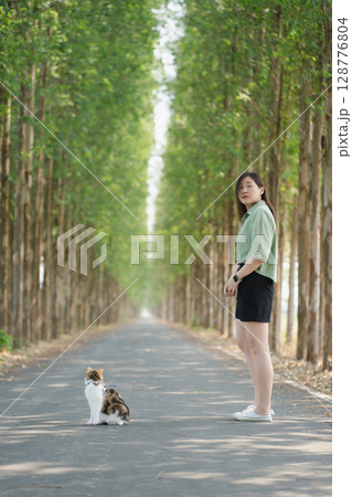 asian woman happy during travel and play with her cat on spring season asian woman happy during travel and play with her cat on spring season 128776804
