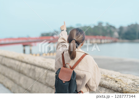 Woman tourist sightseeing Fukuura jima bridge or the bridge of romantic encounters for Fukuura Island at Matsushima Bay in Matsushima, Miyagi Prefecture, Tohoku, Japan. Landmark and famous Vacation Woman tourist sightseeing Fukuura jima bridge or the bridge of romantic encounters for Fukuura Island at Matsushima Bay in Matsushima, Miyagi Prefecture, Tohoku, Japan. Landmark and famous Vacation 128777344