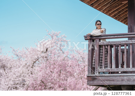 Woman tourist sightseeing Sakura Cherry Blossom in Spring, happy traveler travel in Tendo Park or Maizuru Park in Yamagata prefecture, Tohoku, Japan. famous Landmark for Travel and Vacation 128777361