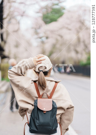 Woman tourist sightseeing Sakura Cherry Blossom in Spring. Happy traveler travel in Samurai village or Little Kyoto in Kakunodate town, Semboku District, Akita Prefecture, Japan. Landmark and Vacation Woman tourist sightseeing Sakura Cherry Blossom in Spring. Happy traveler travel in Samurai village or Little Kyoto in Kakunodate town, Semboku District, Akita Prefecture, Japan. Landmark and Vacation 128777391