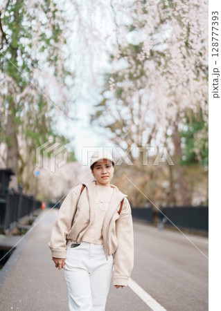 Woman tourist sightseeing Sakura Cherry Blossom in Spring. Happy traveler travel in Samurai village or Little Kyoto in Kakunodate town, Semboku District, Akita Prefecture, Japan. Landmark and Vacation 128777393