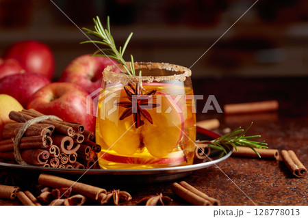 Apple kombucha with apple slices, anise, and a rosemary branch. 128778013