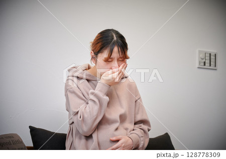 つわりに苦しむ女性　妊婦　マタニティ 128778309