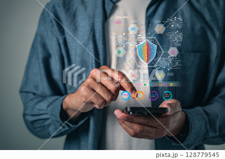 Digital security shield protecting a phone represents cybersecurity, data protection 128779545