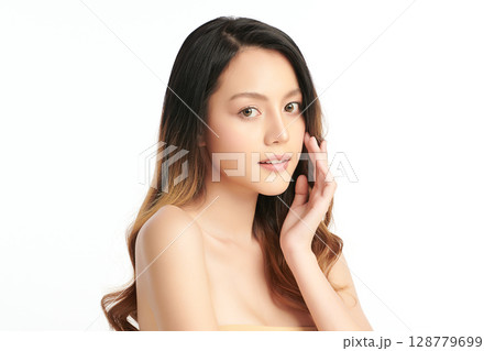 A beautiful young Asian woman with clean, fresh skin against a white background. Skincare, facial treatment, cosmetology, beauty, and spa. An elegant portrait of an Asian woman. 128779699