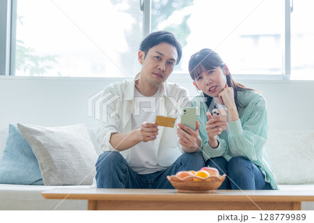 引き落とし金額に落ち込む夫婦 引き落とし金額に落ち込む夫婦 128779989