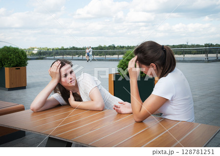 Young girls in a cafe 128781251
