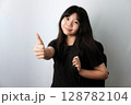 Asian girl in black t-shirt carrying backpack Giving Thumbs Up 128782104