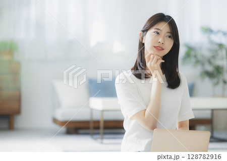 リビングでパソコンを使う若い女性　 128782916