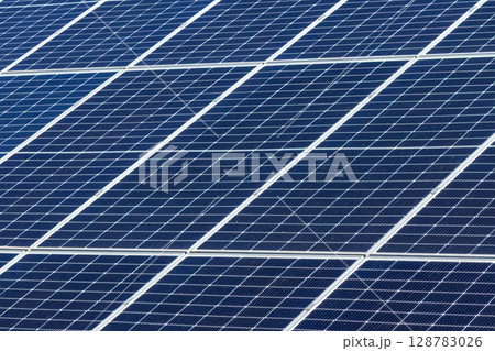 Dark blue photovoltaic solar panels display a detailed grid pattern, symbolizing sustainable renewable energy technology and environmental responsibility for future clean power 128783026
