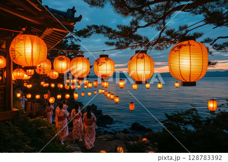 a traditional Obon dance performed at night, participants wearing yukatas dancing in a circle under glowing lanterns, a serene evening sky enhancing the scene 128783392