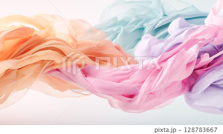 Colorful flowing fabric in soft pastel shades creates a dynamic visual effect, showcasing elegance and movement in a serene atmosphere 128783667