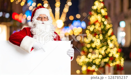 Santa Claus celebrates the winter holiday with a Christmas tree, snow, and presents 128785237