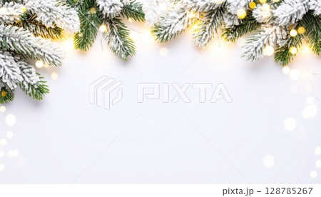 Snow-dusted evergreen branches create a festive Christmas background 128785267
