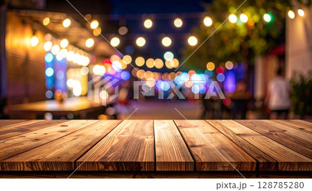 Warm wooden interior of an empty room with abstract light bokeh and blurred city lights outside 128785280