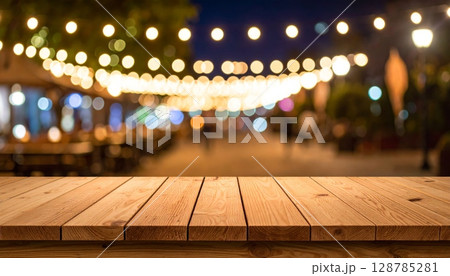 Warm wooden interior of an empty room with abstract light bokeh and blurred city lights outside 128785281