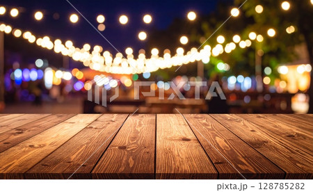 Warm wooden interior of an empty room with abstract light bokeh and blurred city lights outside 128785282