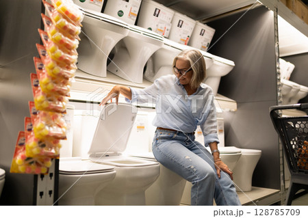 Shopping for home improvement essentials in a large hardware store s bathroom section Shopping for home improvement essentials in a large hardware store s bathroom section 128785709