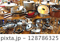 Culinary treasures await among an eclectic collection of pots and pans in a bustling kitchen environment filled with character 128786325