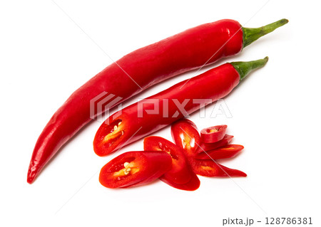 Sliced pods of red natural organic chili pepper on white background Sliced pods of red natural organic chili pepper on white background 128786381