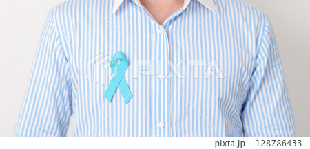 Man with blue Ribbon for concept of blue November, November Prostate Cancer Awareness month, World Diabetes day , Men Health month, International men, Father day. Healthcare and world cancer day Man with blue Ribbon for concept of blue November, November Prostate Cancer Awareness month, World Diabetes day , Men Health month, International men, Father day. Healthcare and world cancer day 128786433